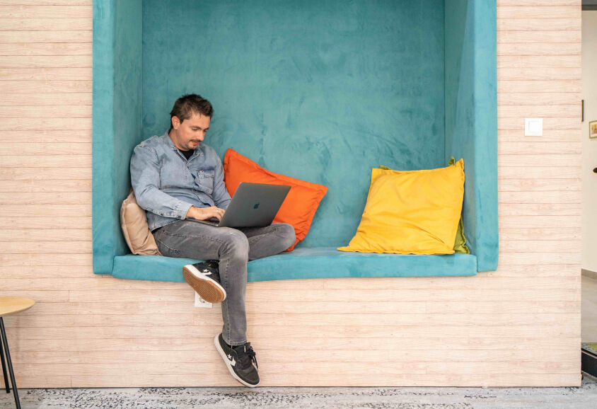 man sitting down with his laptop
