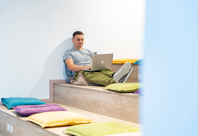 male with a laptop on his lap