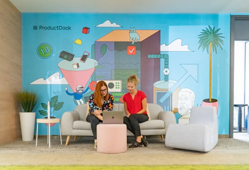 two women looking at a Mac, at ProductDock