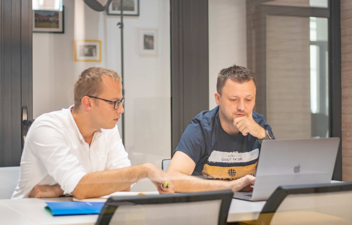 two people working on a laptop