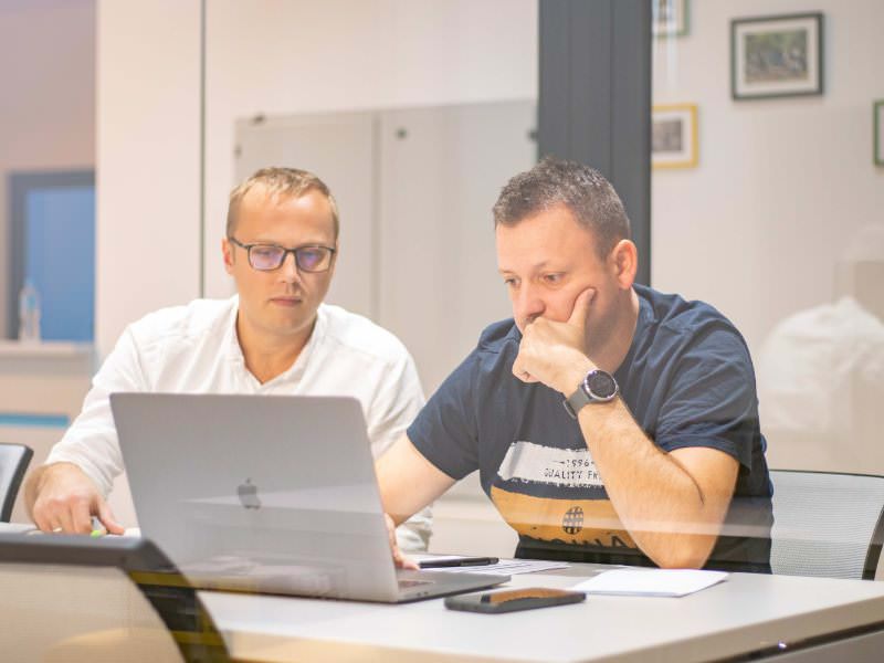 two people working on a laptop